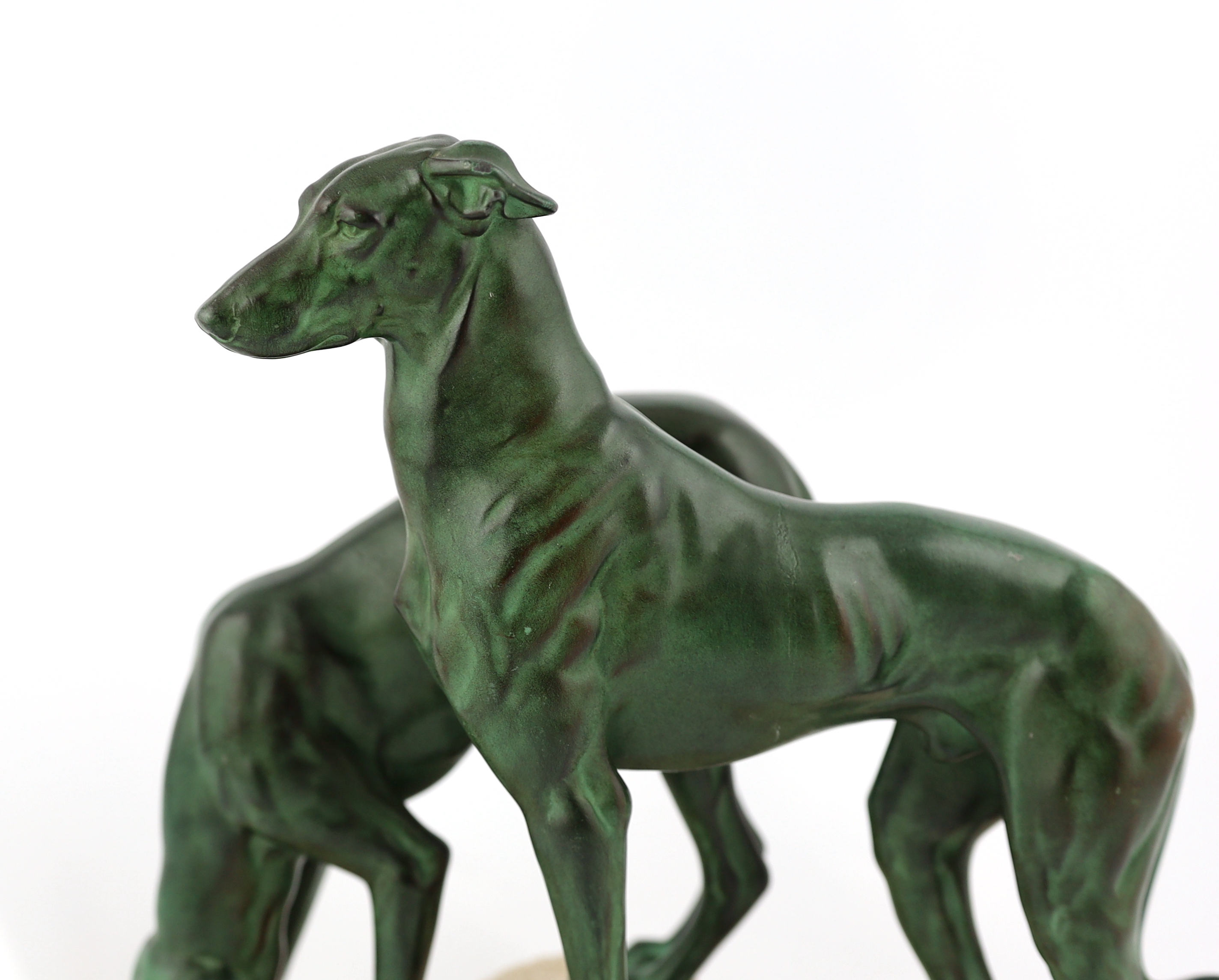 Masson, a French Art Deco spelter and composition stone group of two hounds watering, signed in the base, 32cm long, 12cm deep, 28cm high